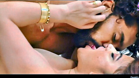 Bearded Indian man passionately French kissing sexy Desi woman with tongues touching