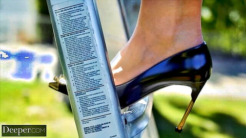 Sexy woman's bare leg and black stiletto high heel stepping on metal ladder outdoors