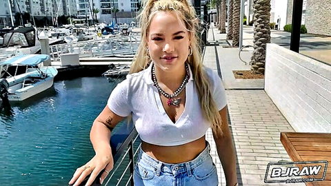 Blonde Mimi White in white crop top and jeans at marina, teasing smile