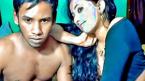 Intimate Indian couple webcam pose, topless man embraced by woman in blue top
