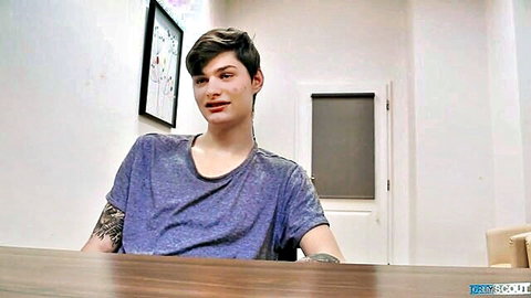 Tattooed young Caucasian guy in loose shirt at office casting desk interview