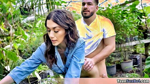 Brunette in denim bent over plants, man behind in garden shop fuck scene