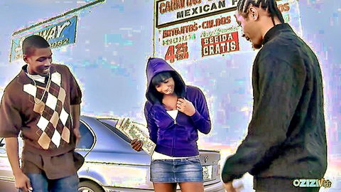 Ebony babe in purple hoodie and mini skirt holds cash with two black guys outdoors