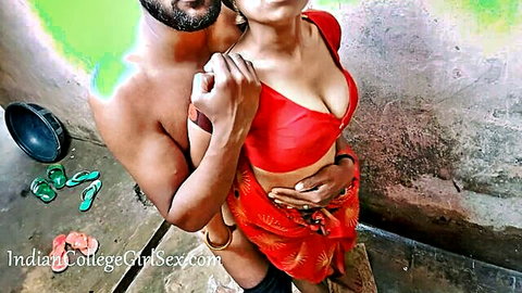 Indian young wife in red saree passionately embraced, ample cleavage