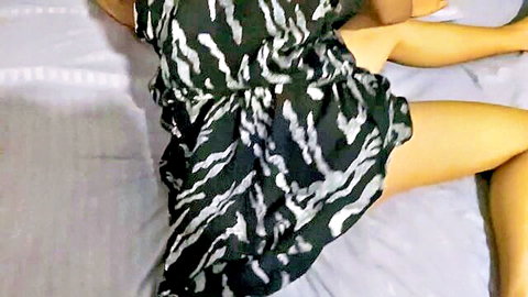 Hot Sri Lankan woman in zebra dress lounging seductively on bed