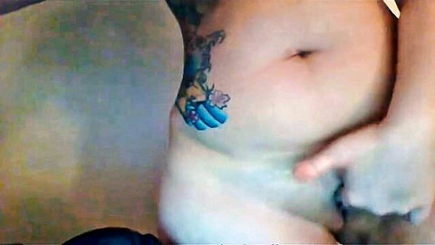 Chubby tattooed babe fingers her creamy pussy on cam