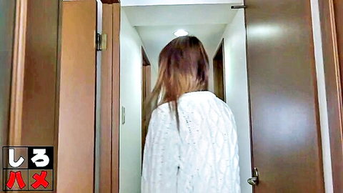 East Asian amateur babe in tight white sweater walking down apartment hallway from behind