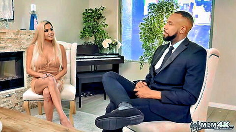 Blonde MILF in low-cut dress interviews with suited black man