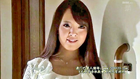 Hitomi Tanaka smiling in ruffled white dress, teasing with massive bust
