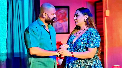 Curvy Indian woman in floral dress embraces bearded man intimately