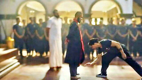 Dramatic Indian movie scene: man in traditional attire kneels before elder in robes