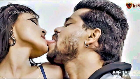 Sexy South Asian woman passionately French kissing bearded hunk with tongue out
