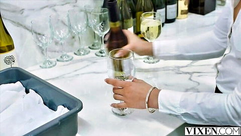 Destiny Cruz elegantly pouring white wine in white blouse