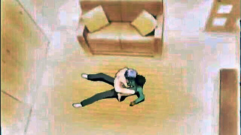 Top-down view of man in jeans pinning clothed guy on living room floor