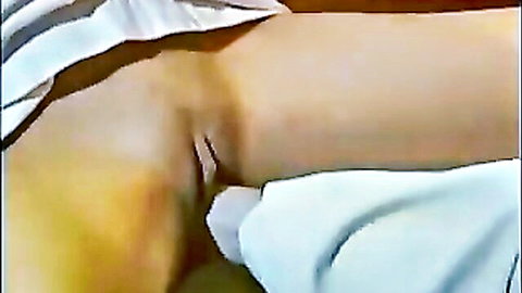 Woman's tight asshole penetrated by thick white dildo with panties pulled aside exposing wet pussy