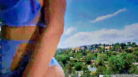Kali Roses in blue top overlooking lush hillside view