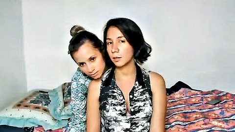 Two hot Latina besties embracing on bed, teasing for cam solo play