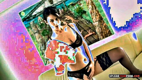 Asian babe in black lingerie and stockings teases seductively on couch