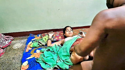 Young Indian housewife in green saree lies spread-legged on bed as man fingers her pussy