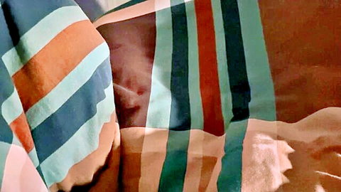 Amy Hide teases in striped fabric on sofa, hinting at perfect pussy