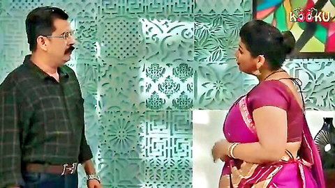 Indian couple in traditional attire, wife in pink saree facing husband in Kooku web series