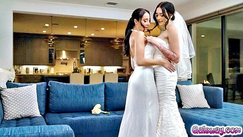 Charlotte Sins and Melissa Stratton embrace intimately in wedding dresses