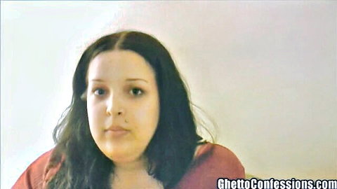 Chubby brunette woman in red top staring at camera in ghetto confessions amateur video