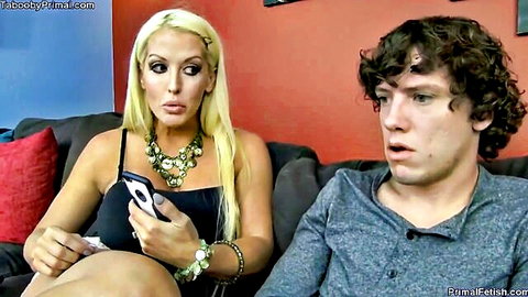 Blonde MILF with huge tits and pouty lips seduces shocked young guy on couch