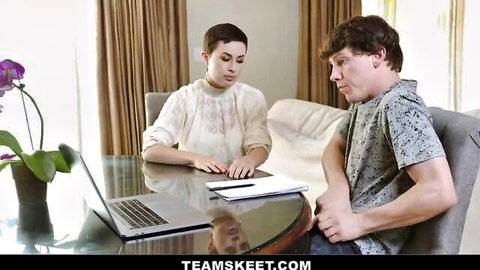 Short-haired MILF in sheer blouse counsels young man at table with laptop