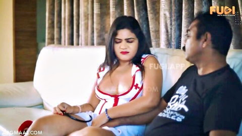 Busty Indian nurse in skimpy uniform showing deep cleavage cuddling with man on sofa