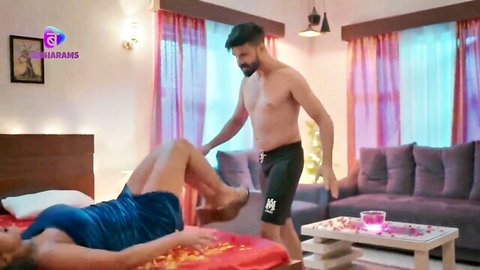 Muscular Indian man grabs busty housewife's thigh as she lifts legs high in blue dress on bed