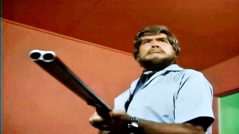 Retro man with shotgun in intense Big Boob Movie cuckold scene