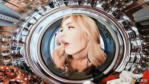 Blonde housewife stuck in washing machine porthole with tongue out seductively
