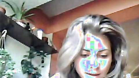 Silver-haired babe with rainbow glitch filter on face in amateur webcam closeup