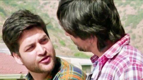 Two Indian men in plaid shirts chatting outdoors in hot Hindi short film
