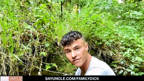 Curly-haired cute stepuncle in white shirt outdoors, bareback family scene