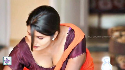 Curvy South Indian aunty in revealing saree with deep cleavage