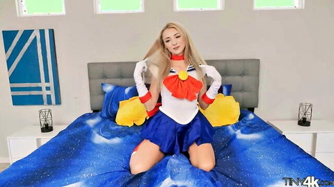 Blonde Sailor Moon cosplayer posing seductively in short skirt