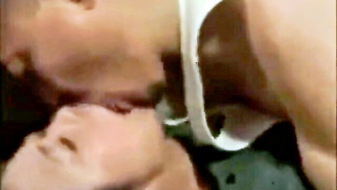 East Asian couple passionately French kissing with open mouths and tongues in steamy closeup