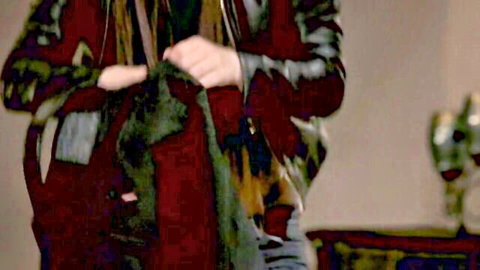 Horny mom in patterned top teasing with hands near crotch