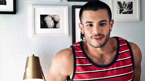 Muscular hairy-chested man smiling in red striped tank top
