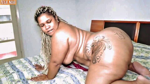 Thick ebony BBW with blonde dreads and huge tattooed ass posing nude doggy style on bed