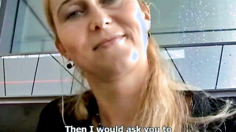 Blonde MILF smiling in car after street pickup, teasing oral action ahead