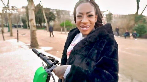 Josy Black ebony model smiling on green scooter in Paris park
