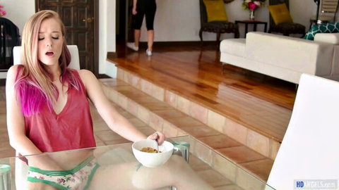Cherie DeVille in red tank top and panties at table with Haley Reed in background