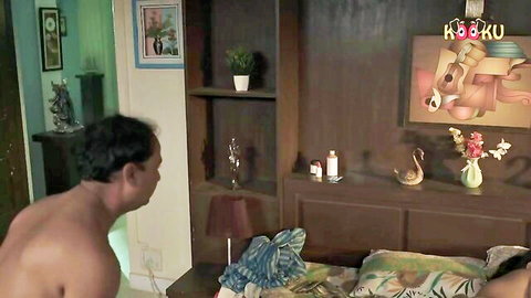 Muscular naked Indian man with bare ass stands over sensual South Asian woman lying teasingly on bed