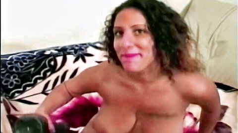 Curvy black babe topless with big breasts in seductive pose