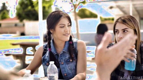 Kendra Spade with pigtails chats with Whitney Wright in casual denim at outdoor gathering