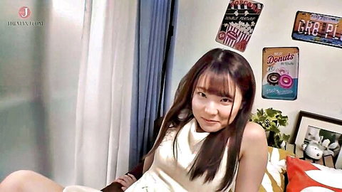 Cute smiling Asian girl in white dress teases with nipple play smile