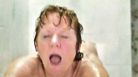 Wet blonde woman nude in shower, mouth open in ecstasy